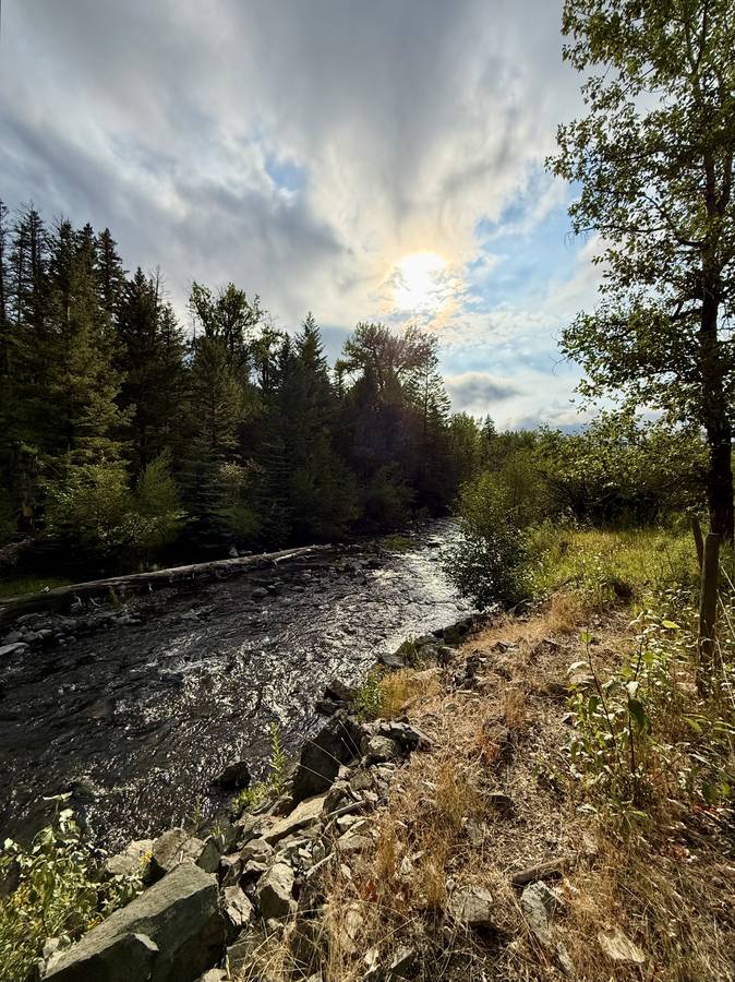 Creek running through the property under an evening sky